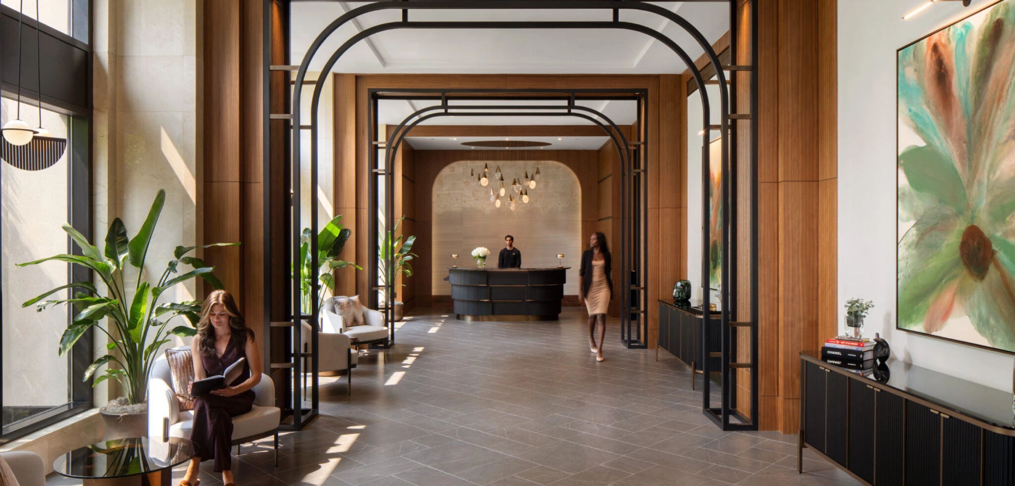 Upscale apartment building lobby featuring concierge desk contemporary design and natural light