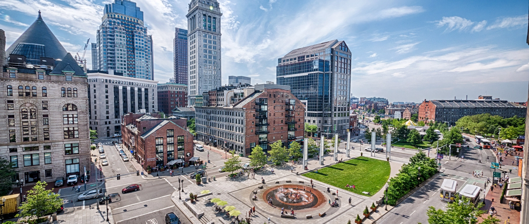 Panoramic downtown scene highlighting walkable streets, landscaped public spaces, and diverse commercial architecture