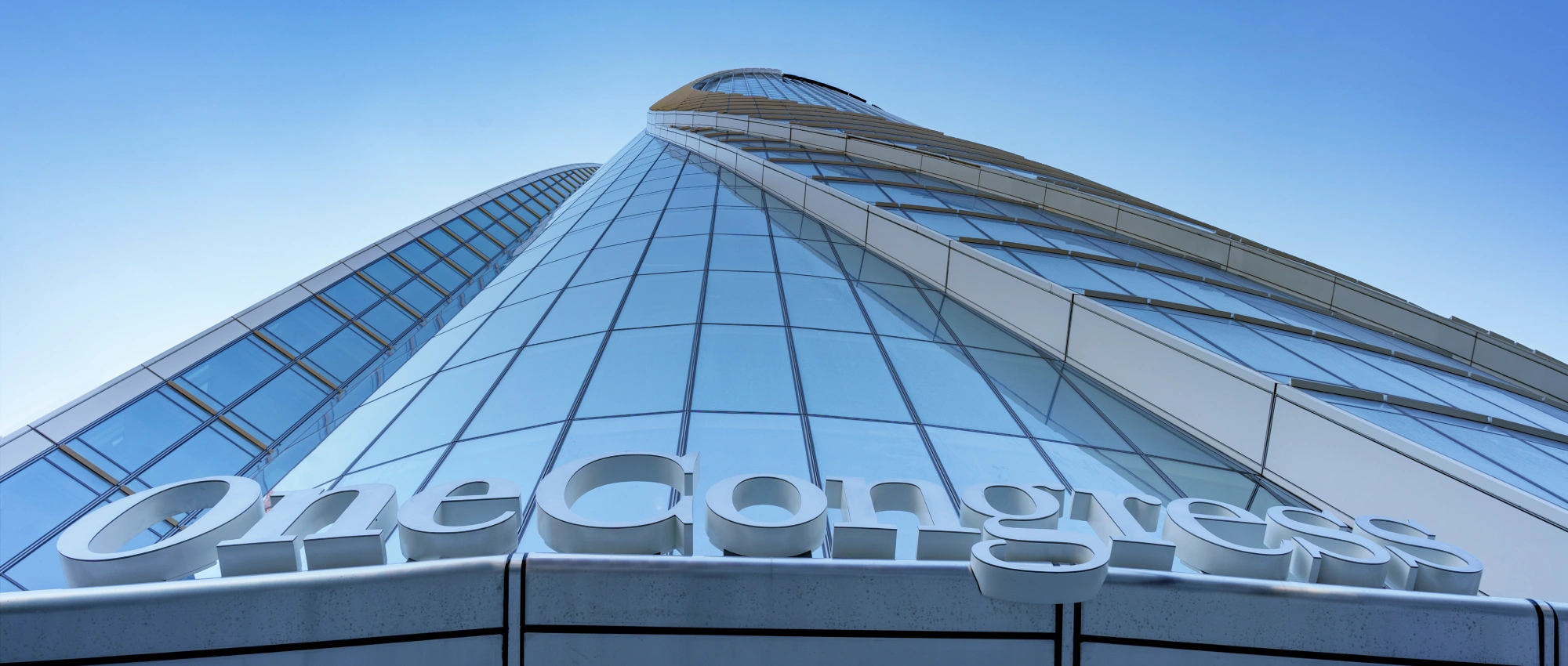 Contemporary One Congress office building exterior showcasing reflective glass panels and distinctive curved design