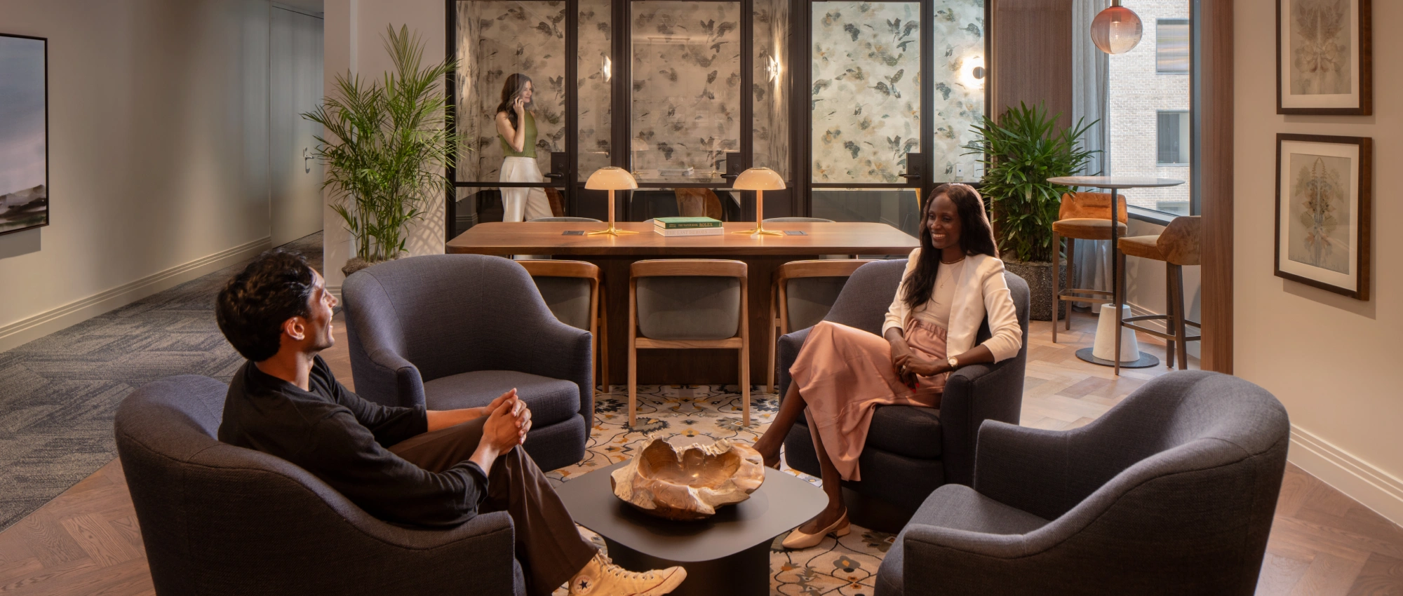 Modern corporate lounge showcasing stylish furnishings, greenery, and a relaxed professional atmosphere