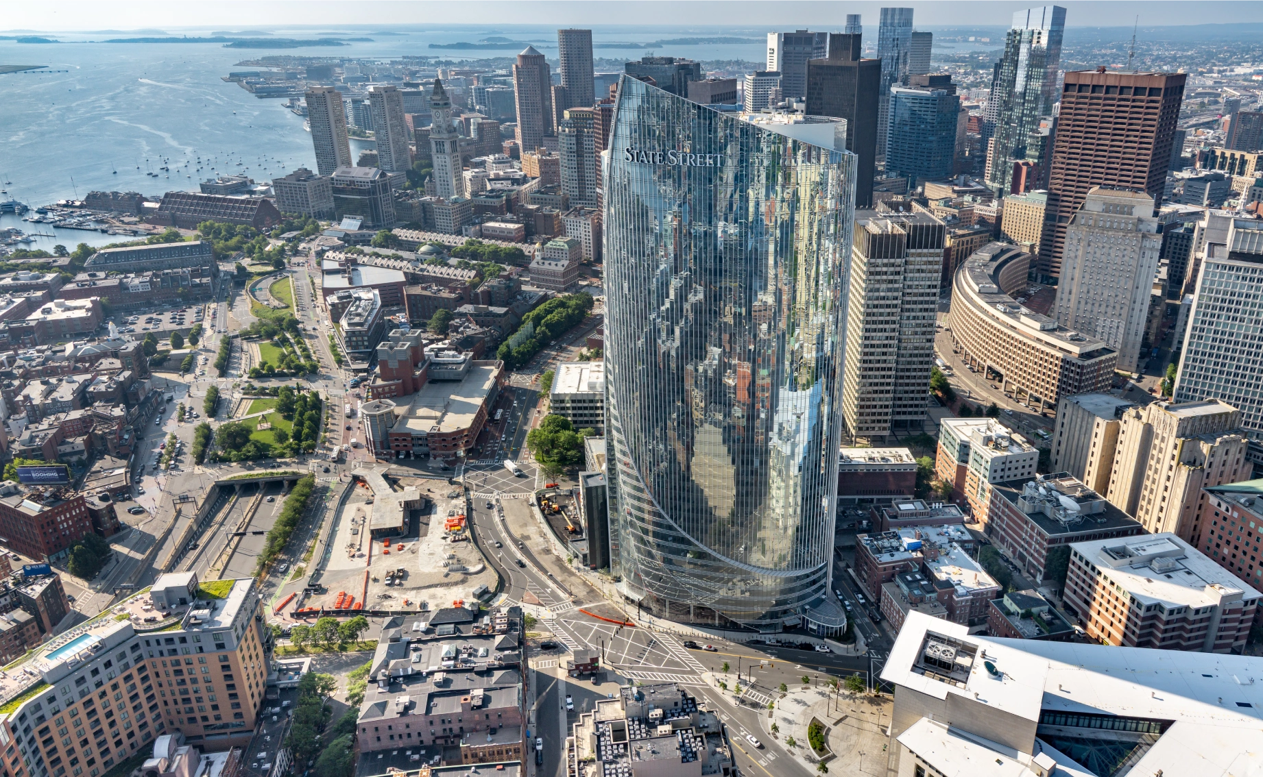 Downtown Boston aerial featuring State Street skyscraper waterfront skyline and surrounding urban architecture