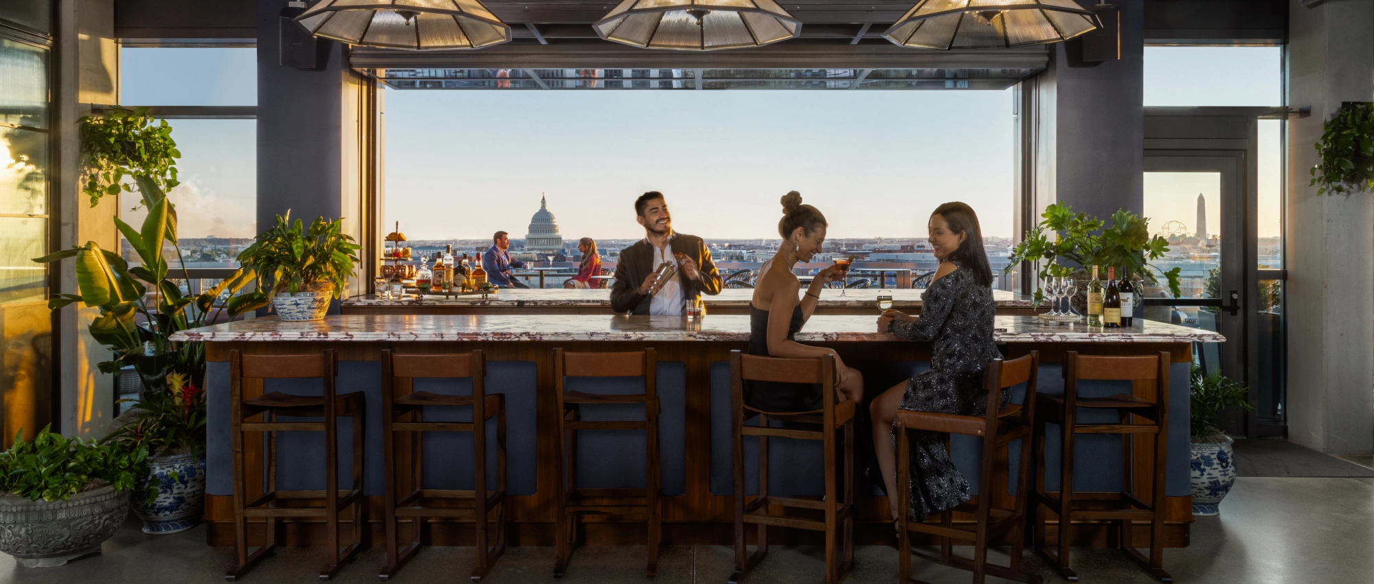 Upscale rooftop gathering space highlighting elegant design, handcrafted drinks, and iconic city scenery