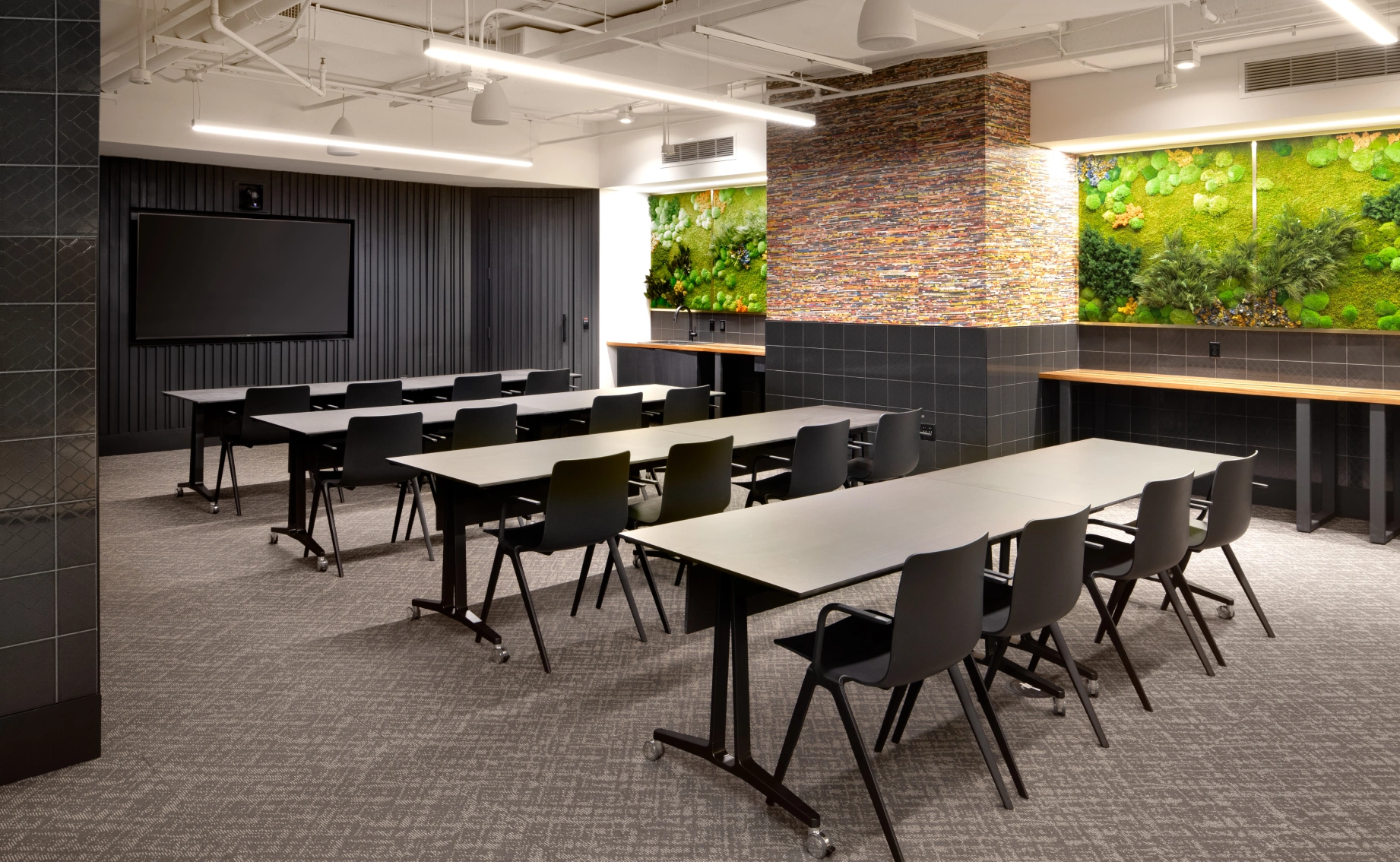 Contemporary workplace classroom featuring long tables ergonomic chairs biophilic design accents walls
