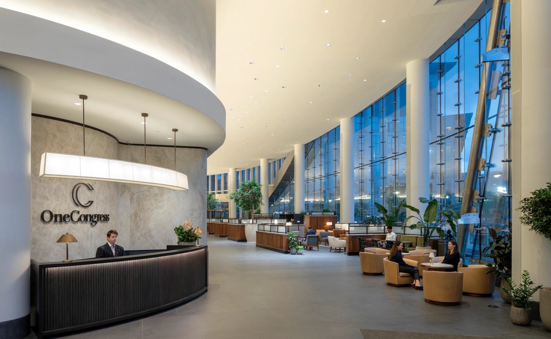 Modern office building reception area showcasing One Congress branding glass walls and upscale lounge furniture