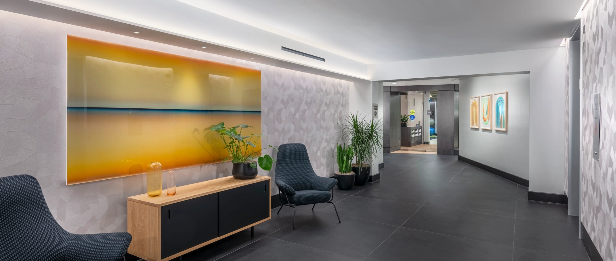 Stylish corporate lobby interior featuring abstract wall art sleek seating integrated lighting and a welcoming design
