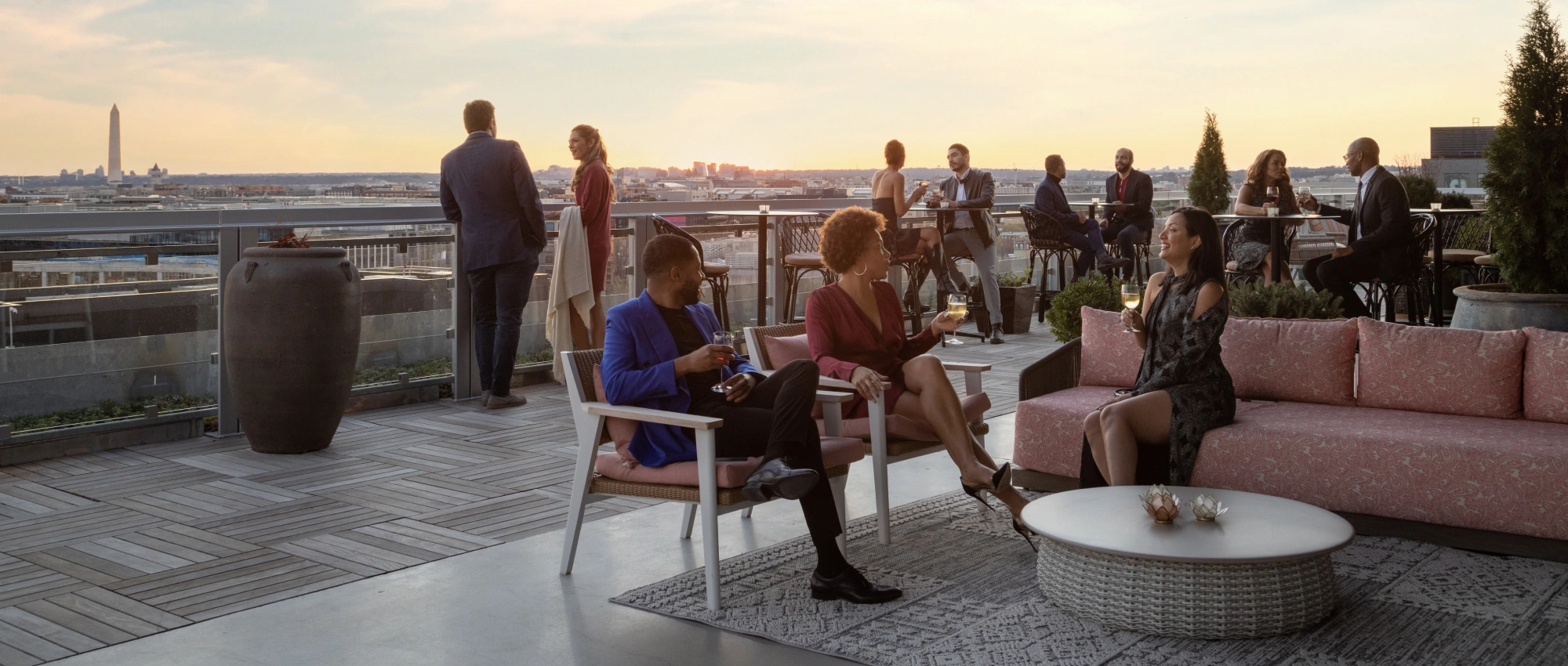 Sophisticated rooftop gathering space showcasing panoramic vistas, refined furnishings, and relaxed conversations
