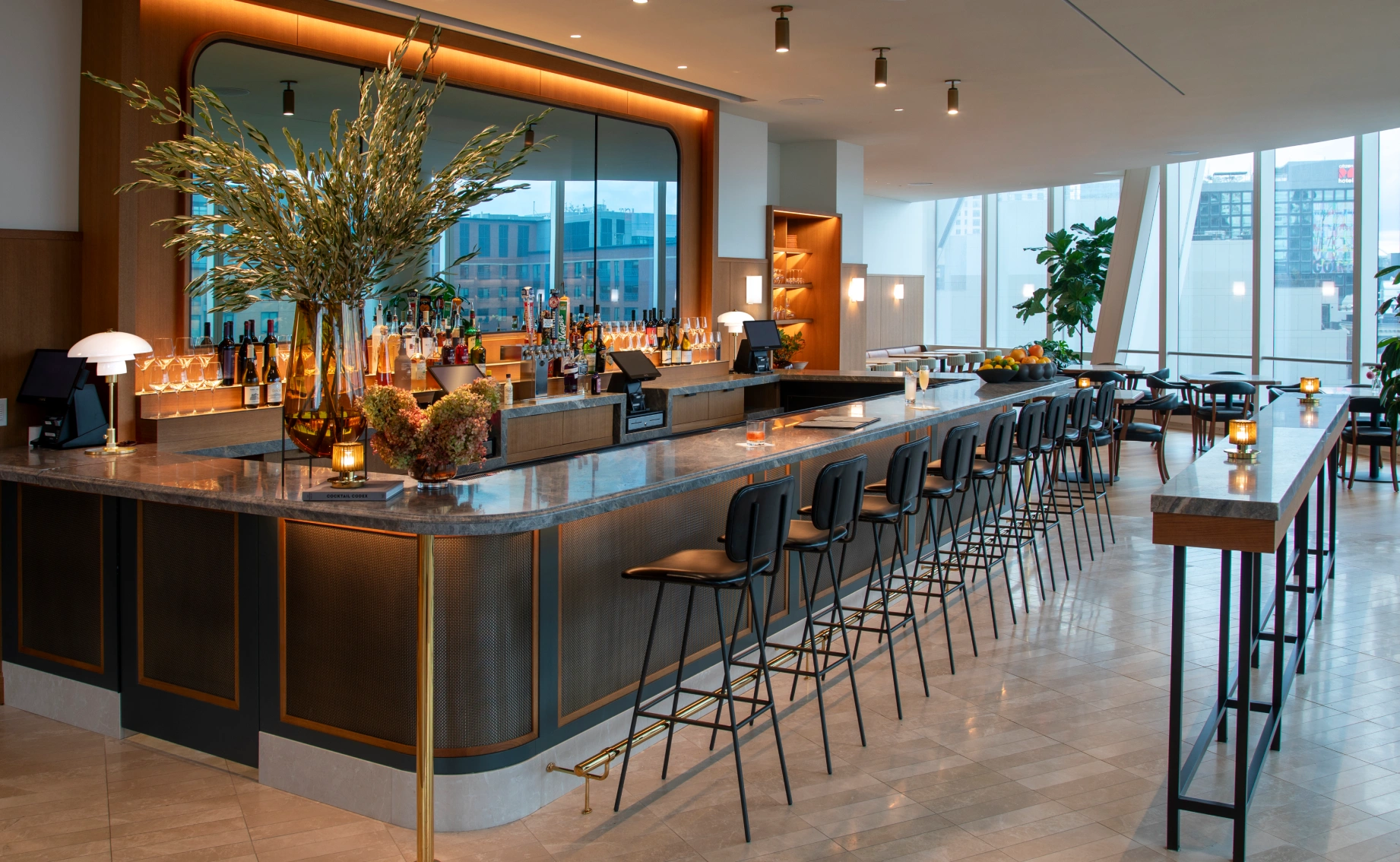 Refined workplace lounge and bar showcasing One Congress design, ambient lighting, and sophisticated communal seating