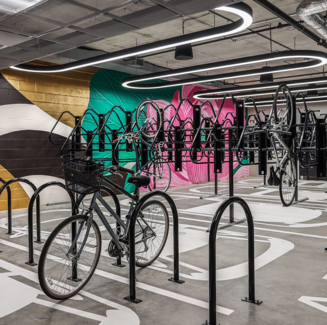 Modern bike parking facility featuring vertical racks contemporary lighting and artistic wall design