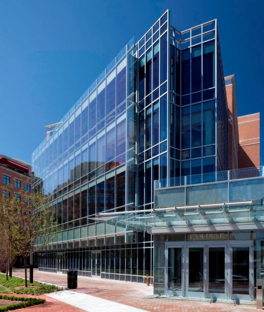 Sleek multi story office building featuring glass walls and modern architectural design