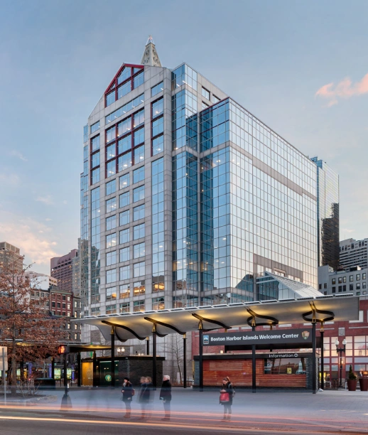 Urban Boston office tower with reflective windows and harbor welcome center entrance