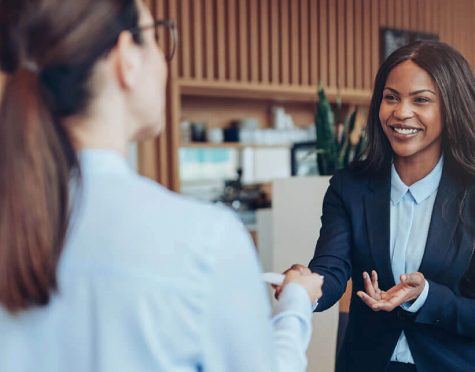 Business interaction between two professionals during welcoming conversation in contemporary workplace setting