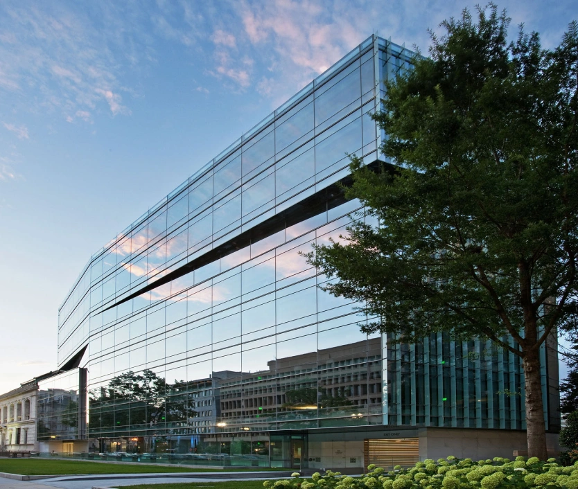 Contemporary corporate architecture featuring clean lines, transparent design, and landscaped greenery
