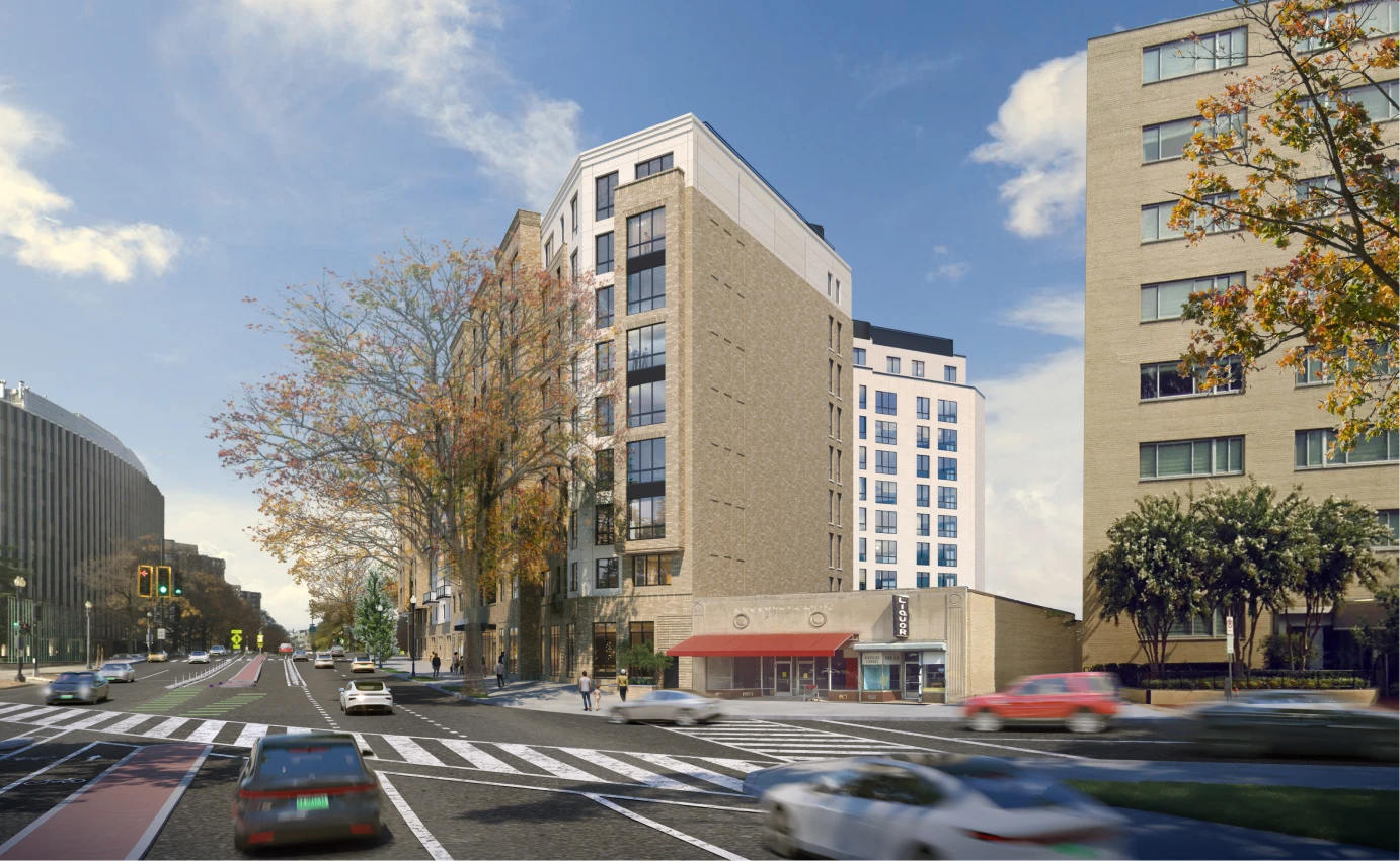 Contemporary mixed-use residential building with street-level storefront, busy intersection, and city skyline