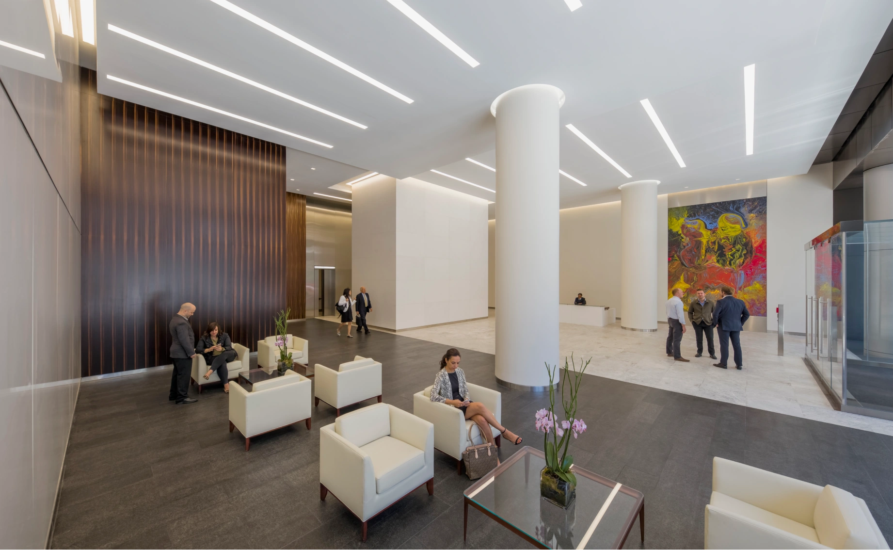 Bright downtown office lobby with minimalist design lounge furniture glass walls and business activity